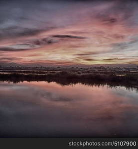 view from water of the sunrise full of colors and rain concept of relax