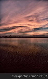 view from water of the sunrise full of colors and rain concept of relax