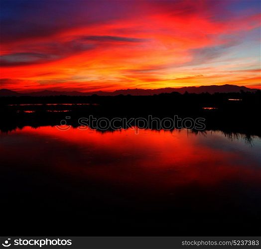 view from water of the sunrise full of colors and rain concept of relax
