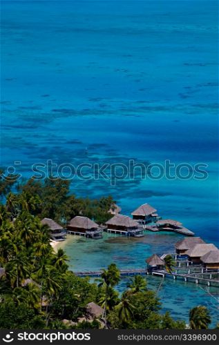 View looking down over a beautiful turquoise lagoon of bungalows. Bora Bora Island, Tahiti, Society Islands, French Polynesia.. Travel and Stock Photography