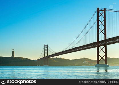 View of 25th of April Bridge at sunset in Lisbon, Portugal