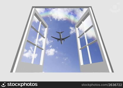 View of a aeroplane gliding through a blue sky through a window frame