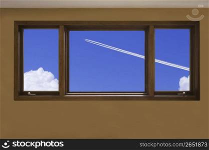 View of a blue sky through a window frame