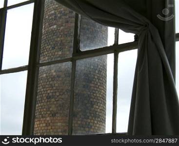 View of a brick chimney through a window