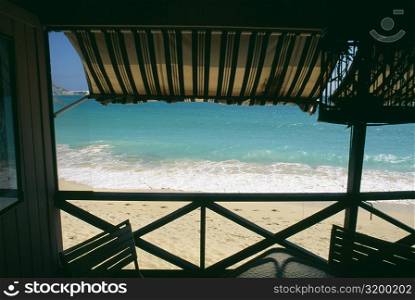 View of a calm beach from the deck of a seaside restaurant, St. Maarten, Caribbean