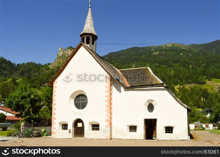 View of a church and chapel typical . View of a church and chapel typical of the Austrian Tyrol with a small garden