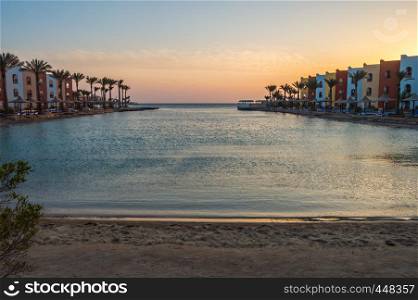 View of a lagoon of the Red Sea at sunrise between two rows of hotel room in Hurghada. View of a lagoon of the Red Sea