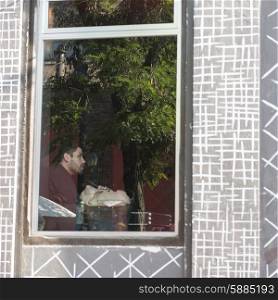 View of a man through window, Santiago, Santiago Metropolitan Region, Chile