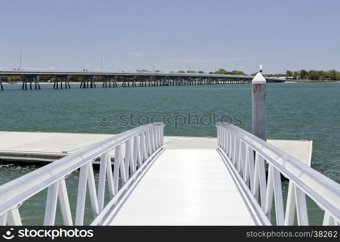 View of a new recreational pier and floating dock at the Pumicestone Passage near the bridge to the Bribie Island, Queensland, Australia