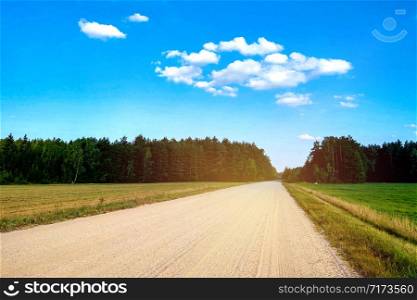 View of a rural country road on a clear day. View of a rural country road on a clear day.