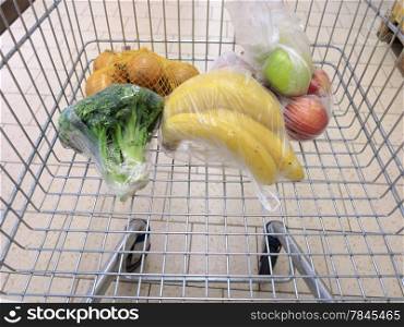 view of a shopping cart with grocery items at supermarket