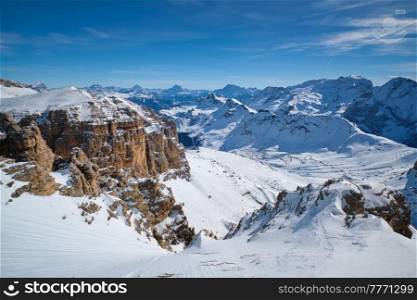 View of a ski resort piste and Dolomites mountains in Italy from Passo Pordoi pass. Arabba, Italy. Ski resort in Dolomites, Italy