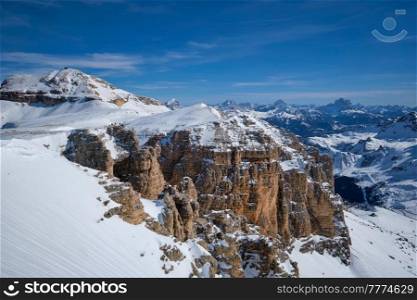 View of a ski resort piste and Dolomites mountains in Italy from Passo Pordoi pass. Arabba, Italy. Ski resort in Dolomites, Italy