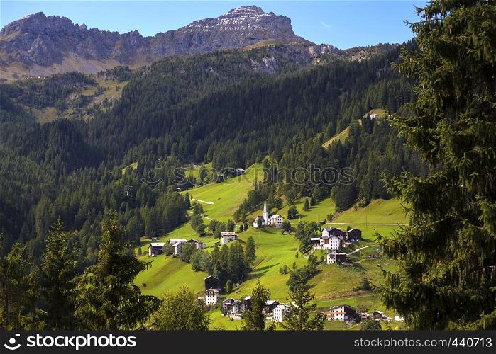 view of a small Typical Italian village located on the slope of the mountains. Dolomites, Italy