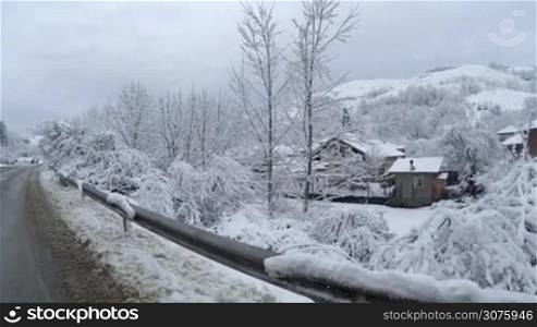 View of a snow covered village in the mountains during winter time.
