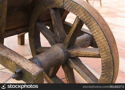 View of a wooden wheel of an ancient wheelbarrow