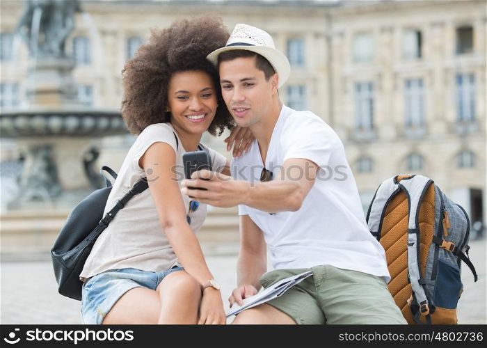 view of a young couple on holidays taking selfie