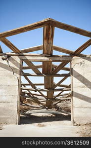 View of abandoned house against clear blue sky