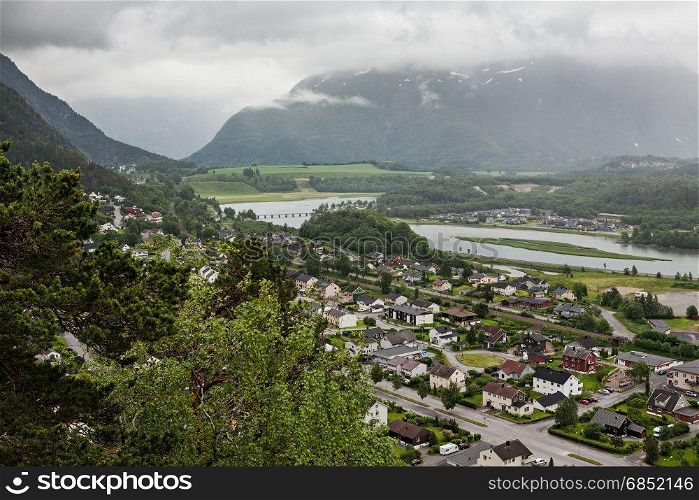 View of Andalsnes city in Norway with mountains on background under a cloudy sky. View of Andalsnes city in Norway