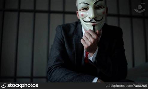 View of Anonymous hacker man in prison