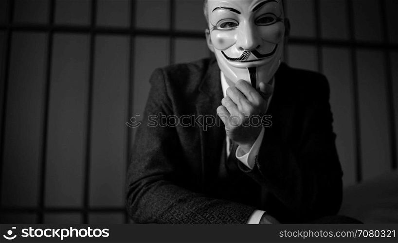 View of Anonymous hacker man in prison (B/W Version)