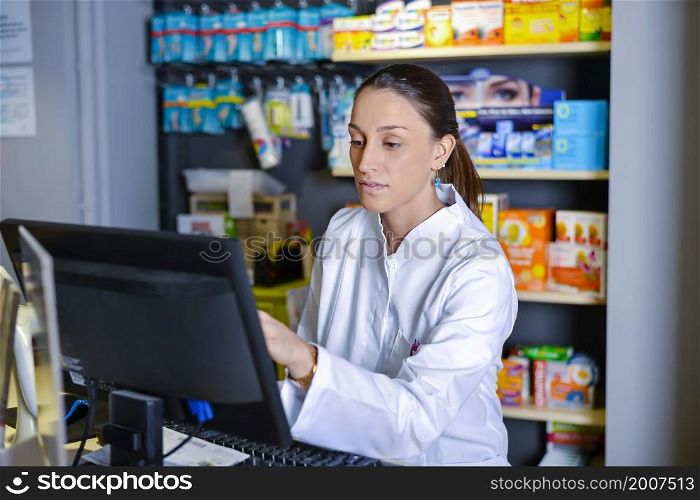 View of attractive pharmacist at work. View of an attractive pharmacist at work