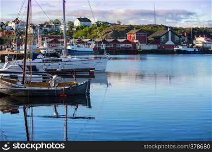 View of bay of morning in a small Swedish town, Sweden. houses and ships against the sky