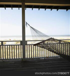 View of beach from porch with railing and hammock at Bald Head Island, North Carolina