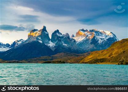 View of beautiful Cuernos del Paine Mountains and Lake Pehoe in Torres del Paine National Park in the evening, Chile