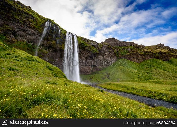 view of beautiful waterfall Seljalandsfoss in summer, south Iceland; selective focus