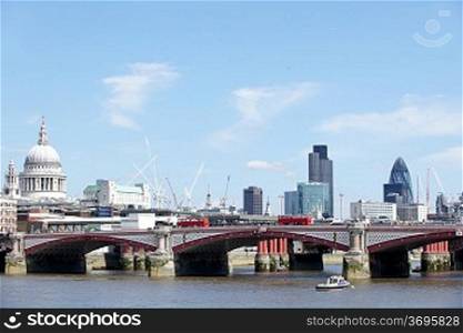 View of Blackfriars bridge with red bus and the city in background