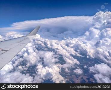 View of blue cloudy sky from airplane window