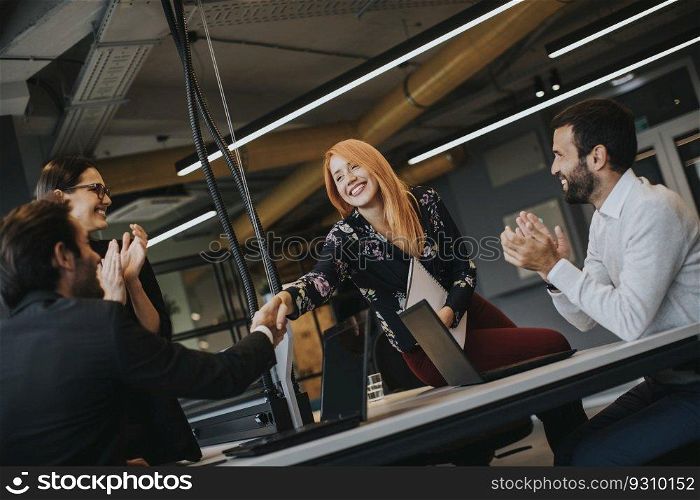 View of businessman executive in group meeting with other businessmen and businesswomen in modern office