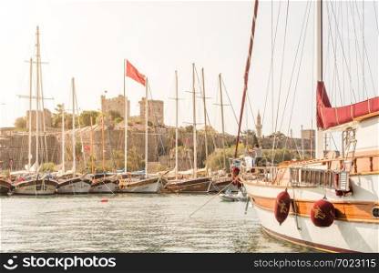 View of Castle of St. Peter,Bodrum Castle and Marine with luxury yachts and sail yachts in Bodrum harbor.Bodrum,Turkey.23 August 2017. . View of Castle of St. Peter,Bodrum Castle and Marine