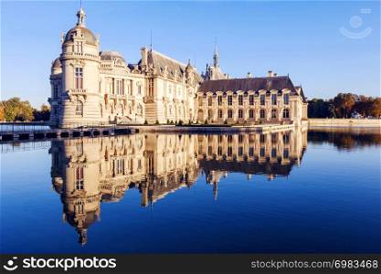 View of Chantilly castle with reflection in water, France. Chantilly castle museum