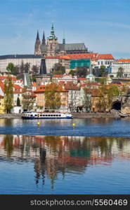 View of Charles bridge over Vltava river and Gradchany (Prague Castle) and St. Vitus Cathedral