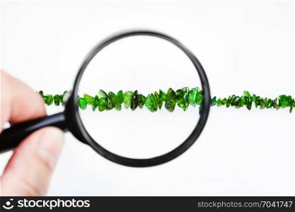 view of chrome diopside crystals through magnifier isolated on white background