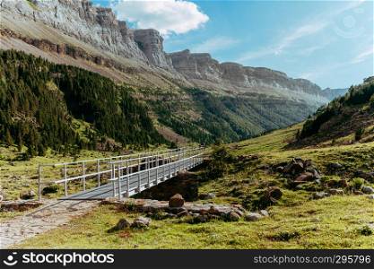 View of Circo de Soaso and bridge in valley, Ordesa National Park, Aragon. Pyrenees Mountains, Spain