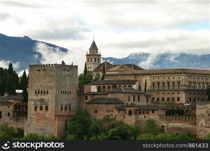 View of city castle Alhambra with mountains in the background in Granada in Spain