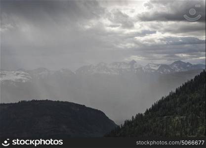 View of clouds over mountain range, Triple Arches, Going-to-the-Sun Road, Glacier National Park, Glacier County, Montana, USA