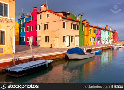 View of colorful houses along the canal on the island of Burano. Burano. Italy. Venice.. Facades of traditional old houses on the island of Burano.