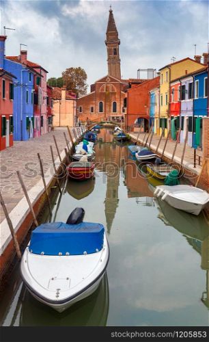 View of colorful houses along the canal on the island of Burano. Burano. Italy. Venice.. Facades of traditional old houses on the island of Burano.