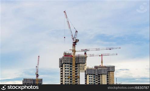 View of Construction site in Downtown Singapore skyline with clouds and crane on top building