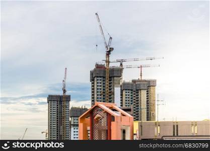 View of Construction site in Downtown Singapore skyline with clouds and sun flare