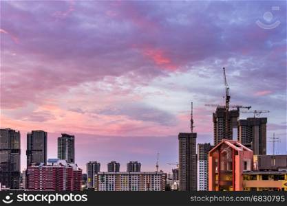 View of Construction site in Downtown Singapore skyline with twilight purple clouds