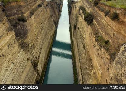 View of Corinth Canal in Greece, which cuts through the narrow Isthmus of Corinth and separates the Peloponnesian peninsula from the Greek mainland. The canal is 6.3 km in length and was built between 1881 and 1893.