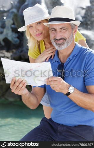 view of couple looking at map at outdoors
