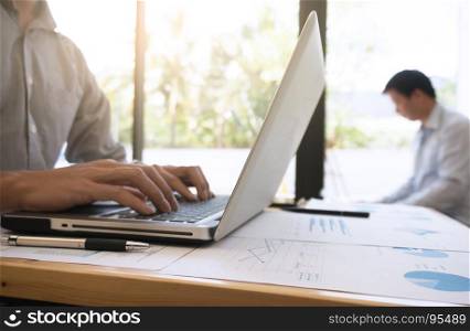 View of Details of business man hands typing on keyboard with blank screen.