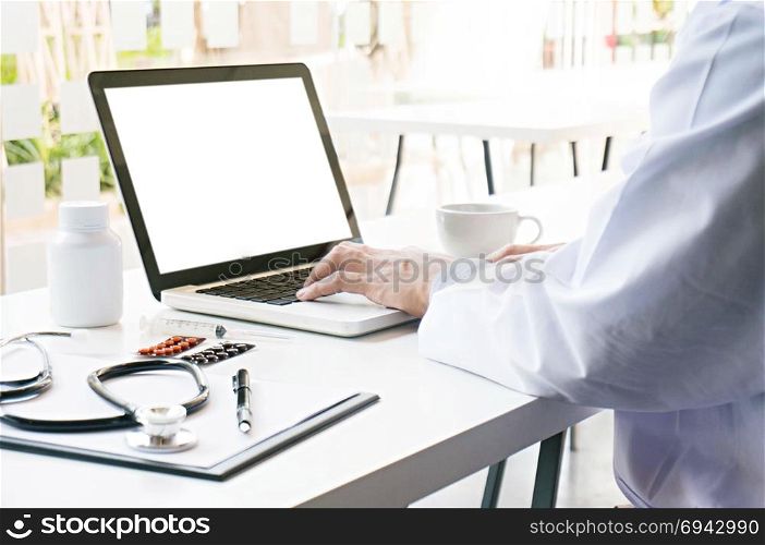 View of Details of doctor hands typing on keyboard with blank screen