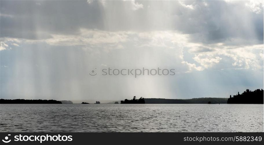 View of distant rain falling at Lake of the Woods, Ontario, Canada
